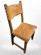 An oak seat with studded leather upholstery,