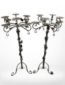 A pair of decorative wrought metal candelabra, height 94 cm.