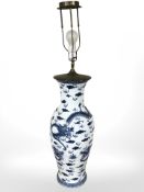 A 20th century Chinese blue and white porcelain baluster vase decorated with four-clawed dragons