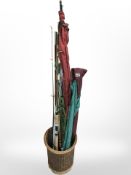 A wicker basket of various fishing rods