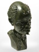 A carved green hardstone bust of an African man by Darios Chikumbirike,
