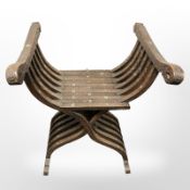 An Islamic carved hardwood savonarola style armchair.