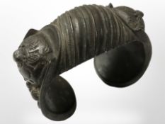 A decorative antique bronze cuff bangle