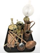 Brass and copper wares including measuring jugs, oil lamp, pestle and mortar.