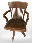 A 1920's oak swivel office chair