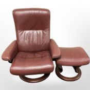A stained bentwood and Burgundy leather swivel lounge armchair and matching footstool.