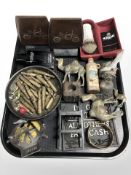 A group of collectables including bullet casings, marbles, AA badge,