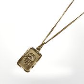An eastern gold pendant upon a 9ct gold chain CONDITION REPORT: Pendant indistinctly