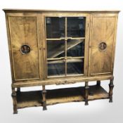 A 20th century continental glazed birch double door sideboard, 150 cm x 47 cm x 138 cm.