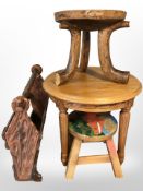A group of wooden furniture including three legged stool, occasional table, mag rack,