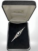 A silver and black onyx mourning brooch
