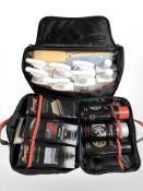 Two satchels containing car care products including polish, cleaner, sponges, etc.