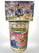 A Teenage Mutant Ninja Turtles metal waste paper bin and a Disney Monopoly game.