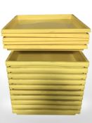 Approximately twenty six shallow plastic square trays, width 52 cm.