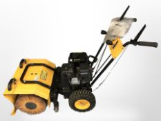 A petrol powered street or pavement sweeper with snow clearance function