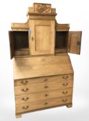 A 19th century oak bureau cabinet, width 118 cm.