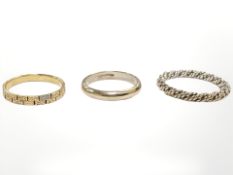 A texture gold band ring, a 9ct gold ring and a further rope twist example.