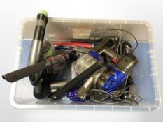 A Gtech handheld vacuum cleaner and a Dyson handheld vacuum cleaner.