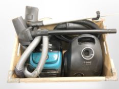 A Hoover vacuum cleaner and a Bosch vacuum cleaner.