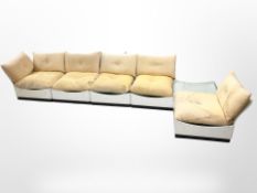 A mid-century modular lounge suite, currently set up as an L-shape with glass topped coffee table,