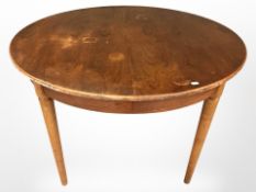A 20th century teak circular extending dining table,