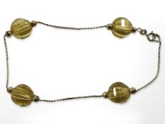 A 9ct yellow gold bracelet with citrine coloured crystals, length 20 cm.