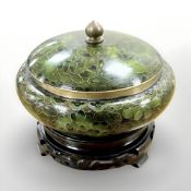 A cloisonne green enamelled pot and cover, standing on wooden plinth,
