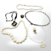 A pearl necklace on gilt metal claps, length 46 cm, together with three further necklaces,