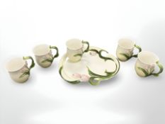 A group of Graff porcelain cups on tray.