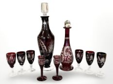 A group of etched ruby tinted glass including two decanters and eight glasses