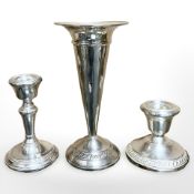 Two silver candlesticks, together with a sterling silver fluted vase, tallest 16.5 cm.