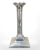 A silver candlestick on square plinth base, height 17 cm.