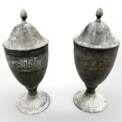 A pair of bronze effect metal lidded urns,