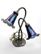 A Tiffany-style bronze-effect table lamp with iridescent glass shade,