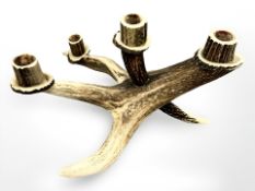 A carved antler table light,