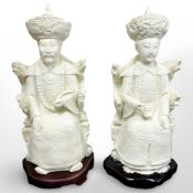 A pair of Chinese carved resin deity figures on stands, height 32 cm.