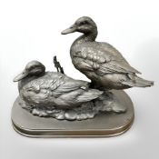 A contemporary bronze effect figure of two ducks, on plinth, height 24 cm.