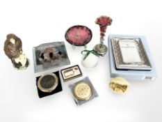 A group of decorative objects including a clock, two compacts, lighter, a Lladro bell,