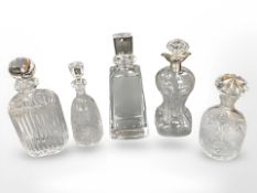 Five cut crystal and glass decanters including a silver mounted decanter,