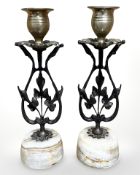 A pair of brass candlesticks on polished stone bases, height 20.5 cm.