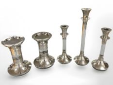 A group of five silver plated candle stands,