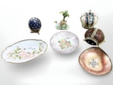 A small group of decorated metal enamelled objects including dishes, egg on stand,