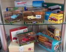 2 shelves of Corgi classics including MGA Jaguar triumph & Mini cooper etc