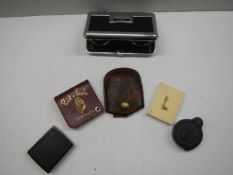 Five folding magnifying glasses and a pair of pocket binoculars.