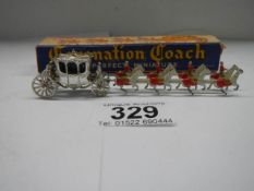 A boxed miniature coronation coach, in good condition.
