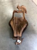 A wooden metamorphic fruit bowl shaped as a pear