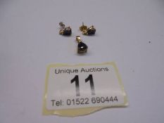 A sapphire and diamond set pendant with matching earrings.