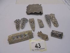 A quantity of paste clips and brooches, art deco in white metal, one stamped 'Kutiklip, ten in total