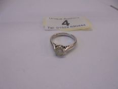 An 18ct white and yellow gold ring set single stone diamond, size I, 2.7 grams.
