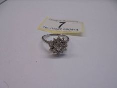 A three quarter carat white gold floral diamond ring, size N, 2.75 grams.